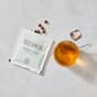 Confezione aperta The Beauty Pearls e tazza di te